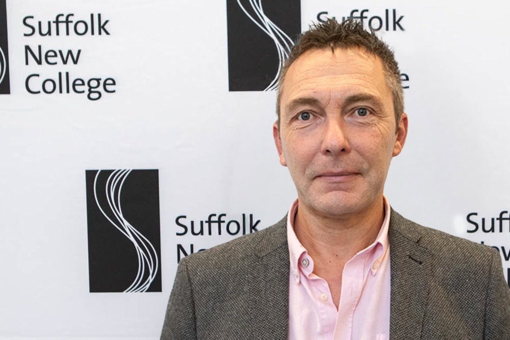 Professional man at Suffolk New College campus promoting higher education and vocational courses in Suffolk, UK.
