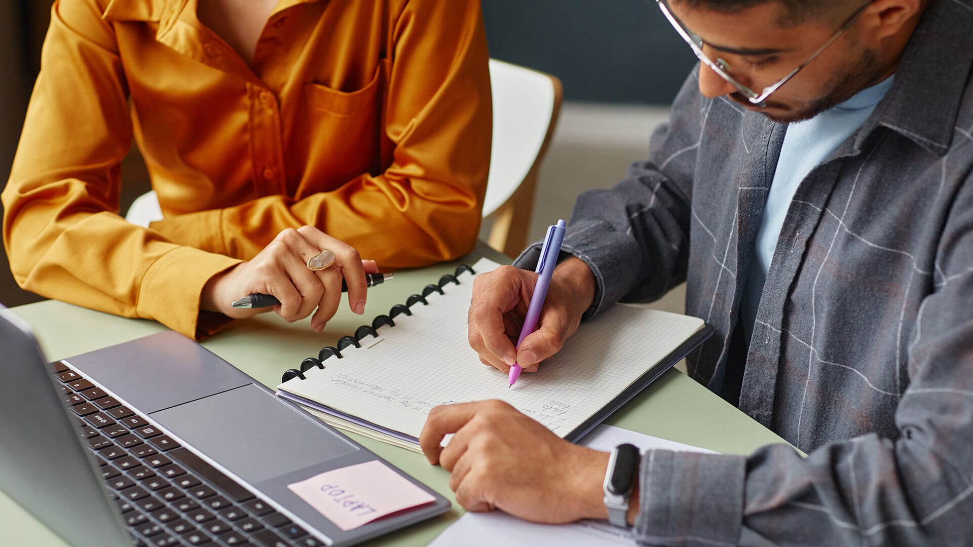Learning Support Practitioner assisting a learner with written work