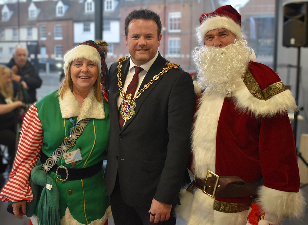 Festive event featuring staff and Santa at Suffolk New College, celebrating holiday season and community spirit.