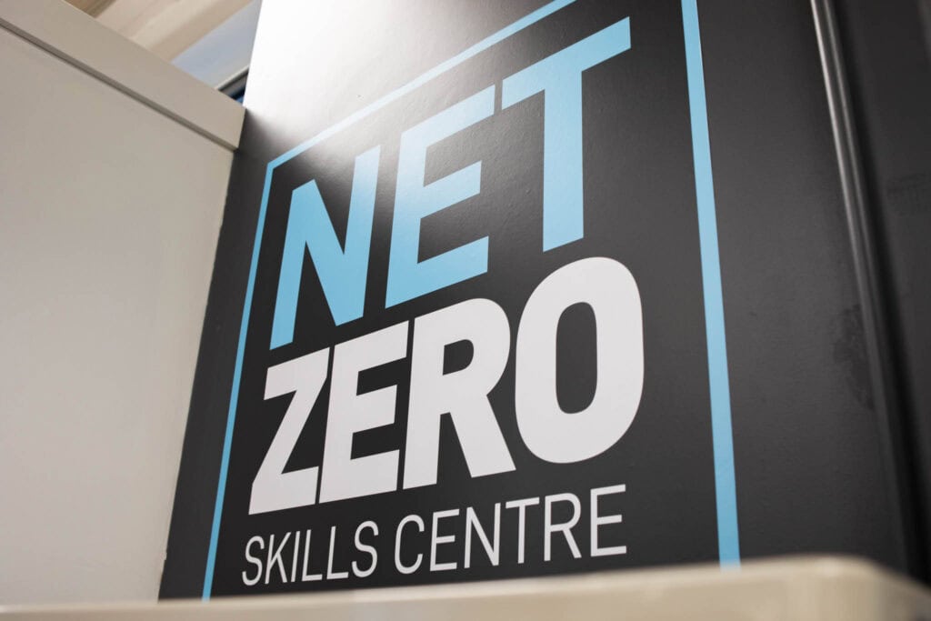 A sign for the NEET Zero Skills Centre at Suffolk New College, promoting skills development and training in a modern educational environment in Suffolk, UK.