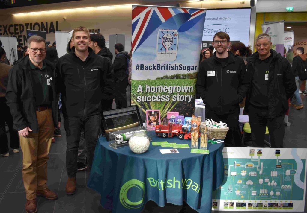 Promotional display of Suffolk New College's success in sports and education, showcasing student achievements, community engagement, and collaboration with British Sugar at Ipswich event.