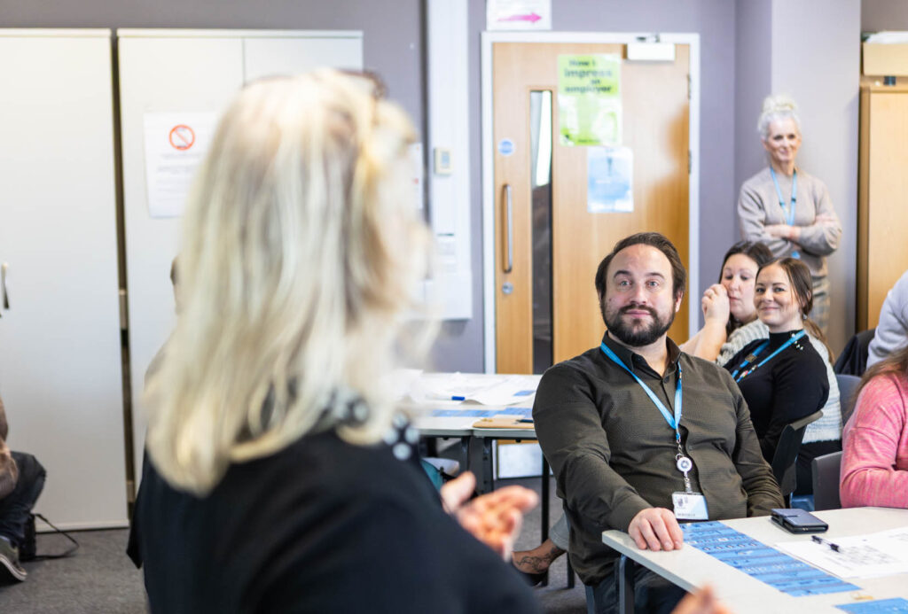 A diverse group of students participating in a classroom lecture at Suffolk New College, gaining higher education and vocational training.