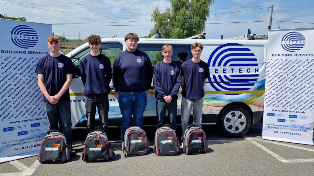Young electrical apprentices standing in front of a Suffolk New College vehicle, showcasing industry partnership and apprenticeship opportunities in electrical and mechanical trades.