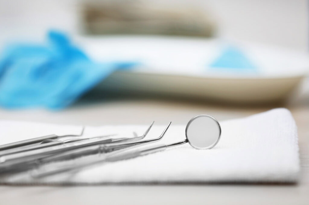 Close-up of dental tools on a white cloth, highlighting dental nursing equipment used in clinical training at Suffolk New College.