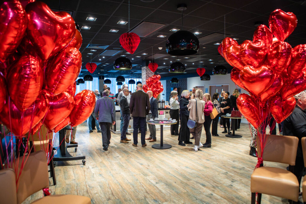 Suffolk New College hosts a Valentine's themed event with industry partners and apprentices, featuring heart-shaped balloons and a festive atmosphere to celebrate industry collaboration.