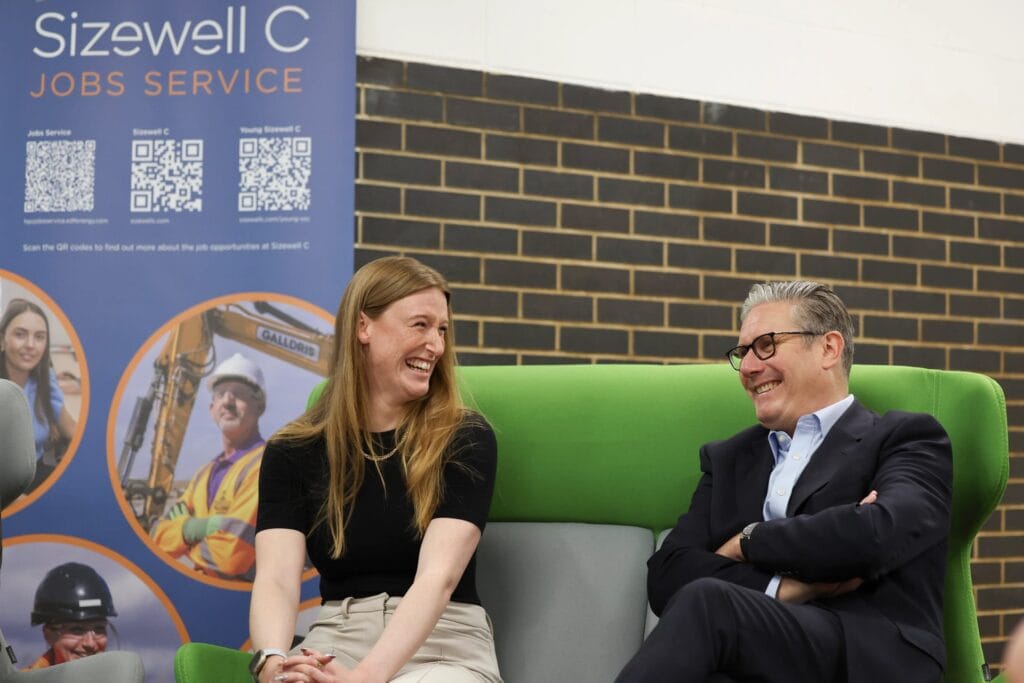 Gemma, a civil engineer apprentice at Suffolk New College, receiving the Apprentice of the Year award, during a college event with a college staff member, in a modern college setting.