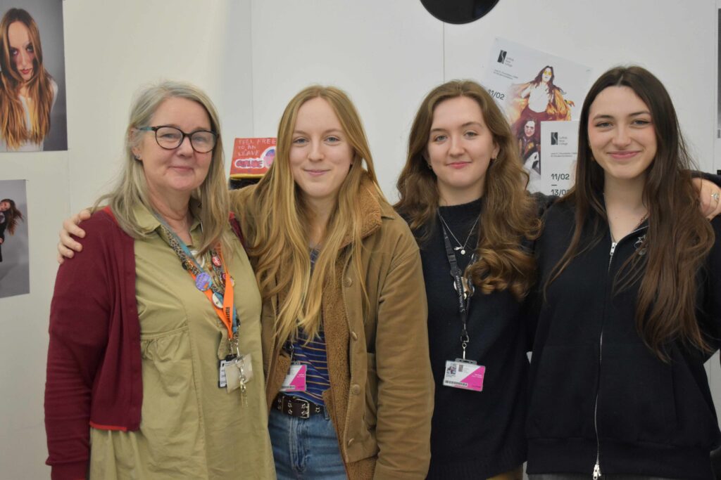 Group of four young women and an instructor at Suffolk New College, exploring arts and creative passions before university, showcasing college's supportive learning environment.