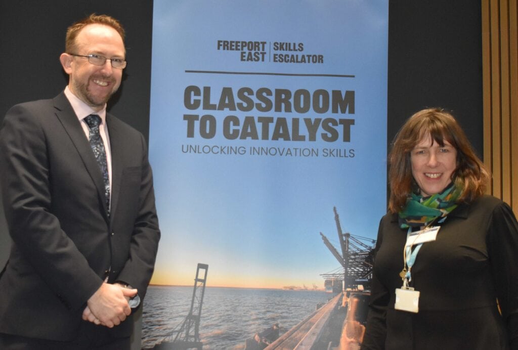 Two professionals at Suffolk New College during a business event, promoting innovation and skills development for aspiring entrepreneurs in Suffolk.