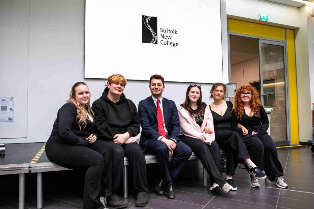 Students sitting together at Suffolk New College, Ipswich, highlighting a diverse group of young learners in a modern educational environment.