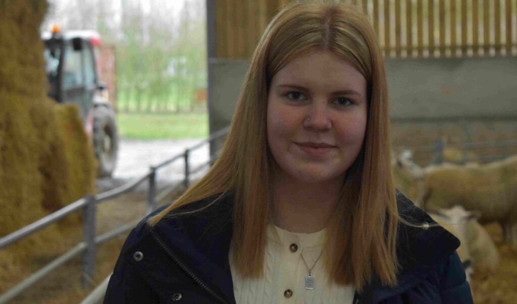 A young woman with red hair smiling at Suffolk New College, showcasing increased female participation in agricultural courses and rural farming education.