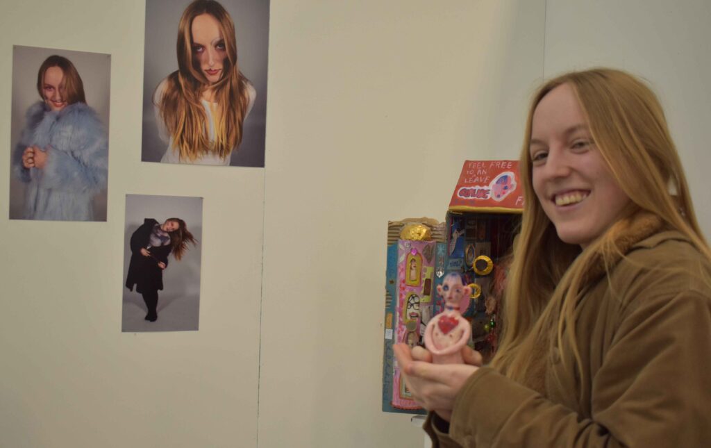 Two students at Suffolk New College engaging with art displays, showcasing their passion for the arts before pursuing degrees at Cambridge University.