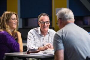 Group of adult students engaging in a discussion at Suffolk New College, promoting adult education and community learning in Suffolk.