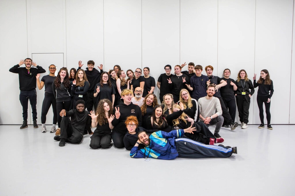 Group of diverse students at Suffolk New College, celebrating their achievements in performing arts, supported by arts collaborations with Sizewell Creative, DanceEast, and New Wolsey Theatre.