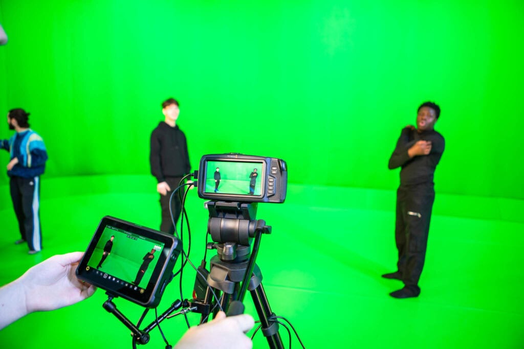 Students and a presenter working with a green screen for media production at Suffolk New College, showcasing skills in digital media and arts collaboration.