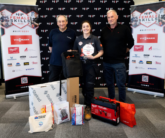 A young apprentice plumber from Suffolk New College receiving recognition at the Hip Female Skills Awards 2023, with two industry professionals celebrating his achievement.