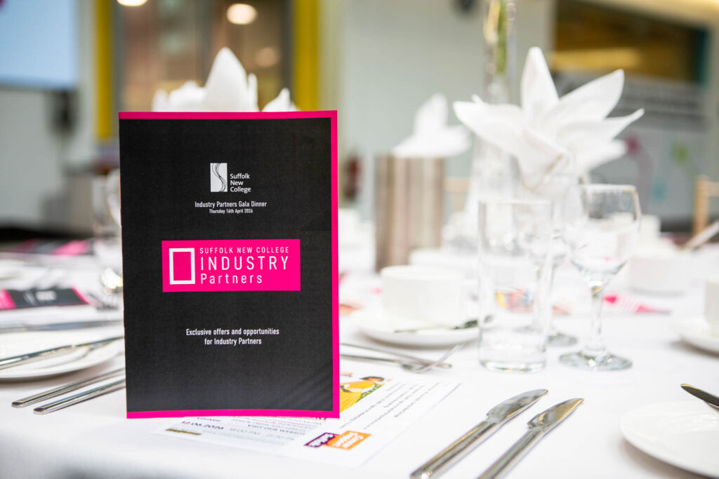 Suffolk New College Industry Partners sign displayed on a table at an event, highlighting collaboration with 200 industry partners during the annual dinner celebration.