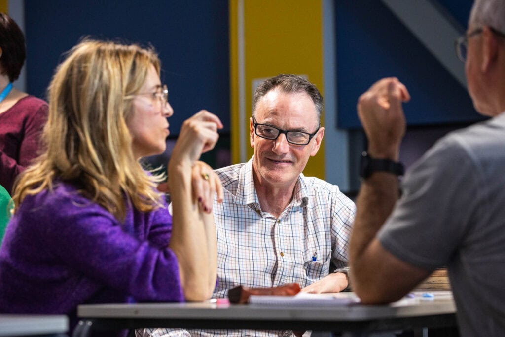 Group of adults engaging in leisure learning activities at Suffolk New College, participating in a social and educational session focused on personal development and skill-building.