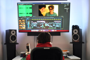 Student engaged in video editing and digital media production using professional software at Suffolk New College, part of the Digital Industries course.