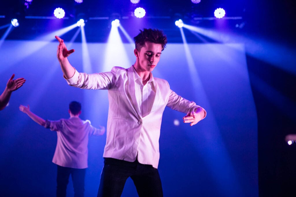 Students at Suffolk New College dancing on stage during a production inspired by Stranger Things, showcasing their talent and creativity in performing arts.