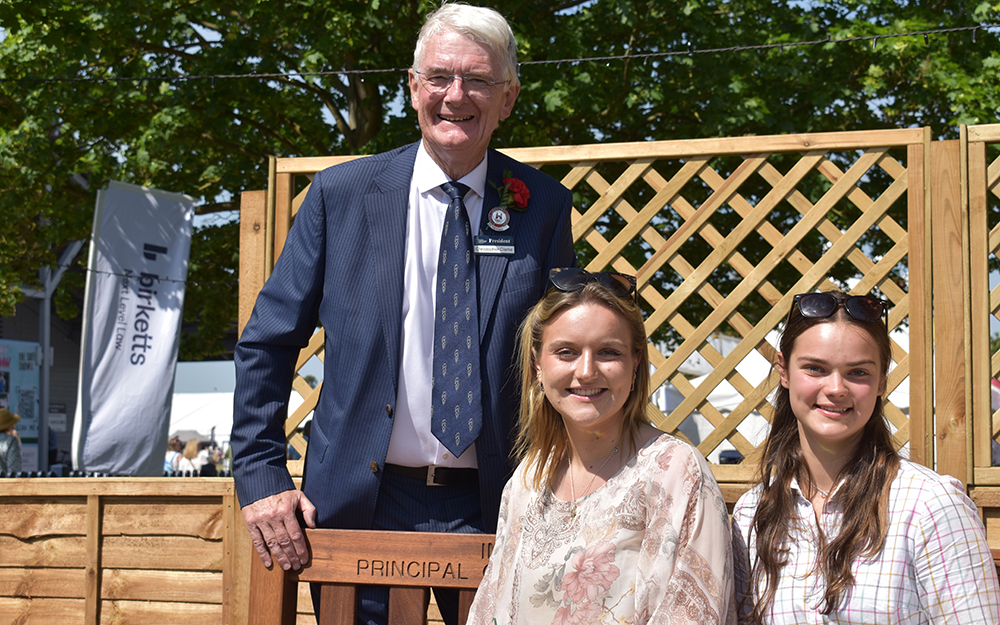 Suffolk New College principal with two students outdoors during a college event, showcasing a welcoming educational environment and community engagement.