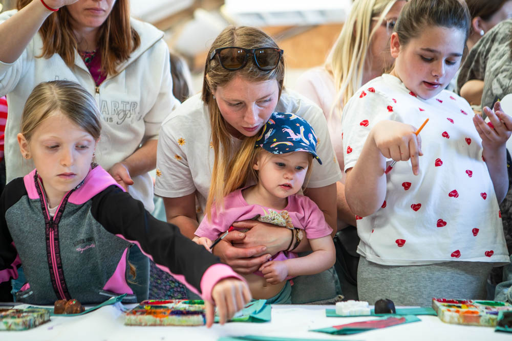 Children participating in arts and crafts during Suffolk New College's family fun day event.