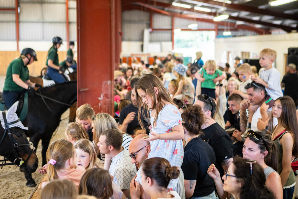 Family fun day at Suffolk New College with children and adults enjoying activities indoors during the annual event.