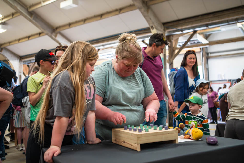 Family fun day at Suffolk New College with children and adults enjoying activities indoors.