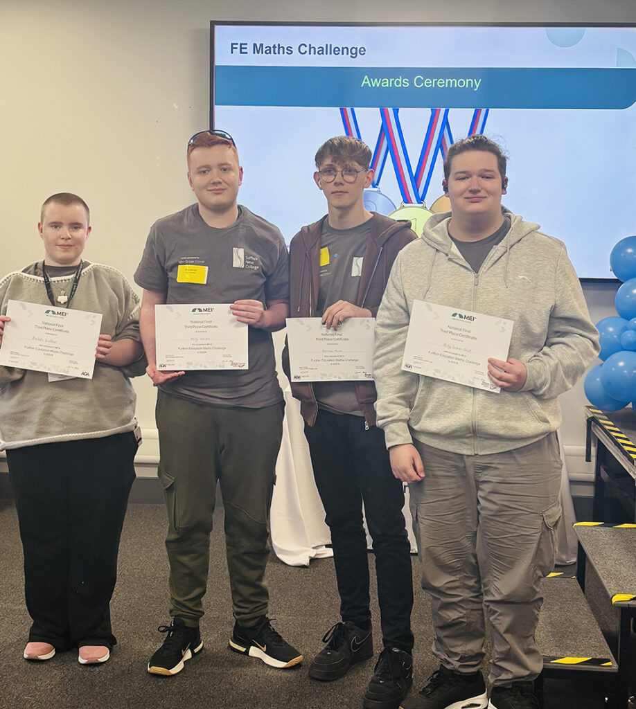 Four Suffolk New College students holding certificates at the awards ceremony for their third-place finish in the national maths competition, celebrating academic achievement.