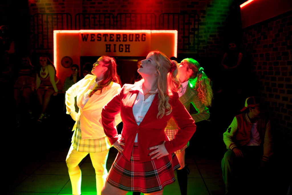 Students performing a dance routine at Suffolk New College, showcasing creative arts and performing arts programs in a vibrant, colourful setting.