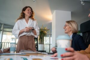 An engaging scene of Suffolk New College staff collaborating and discussing in a bright, modern classroom setting, highlighting professional development and teamwork.