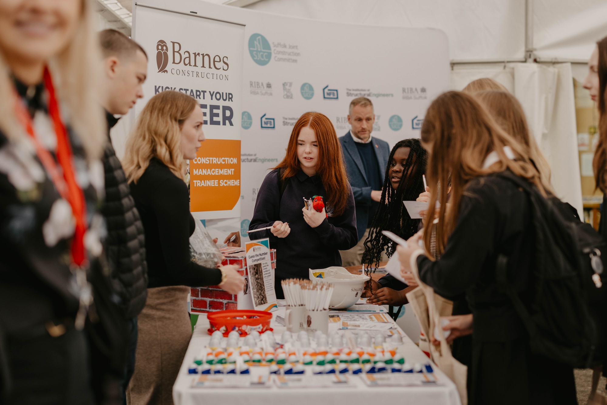 Students engaging at Suffolk New College's FutureSkills Fair, exploring construction management and training opportunities in a lively event setting.
