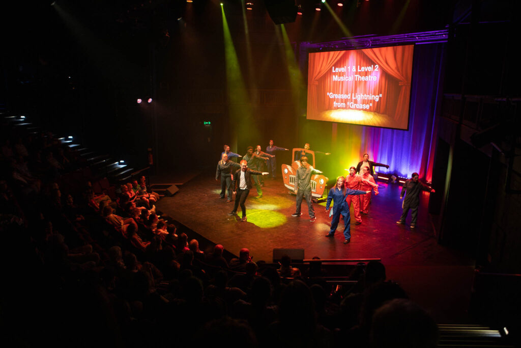 Students showcase creative careers on stage at Suffolk New College theatre during a live performance event.